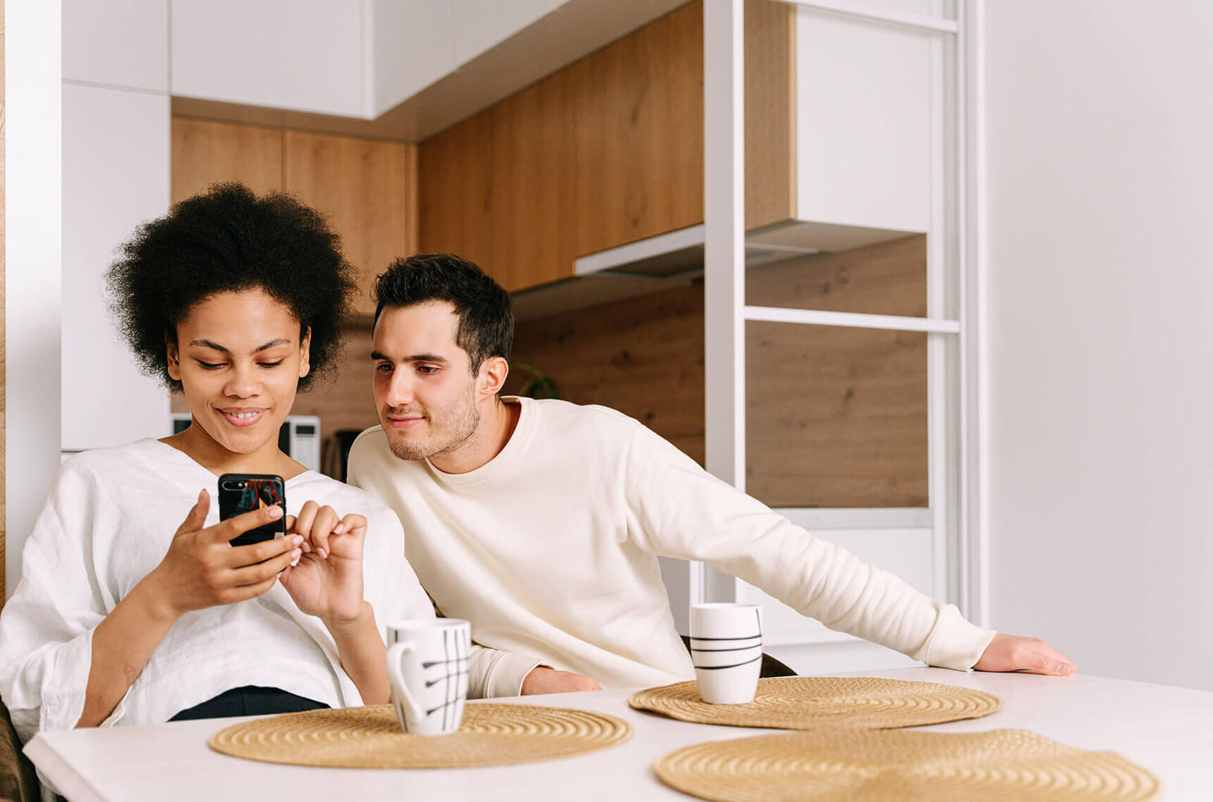 Couple reviewing their finances together on a smartphone